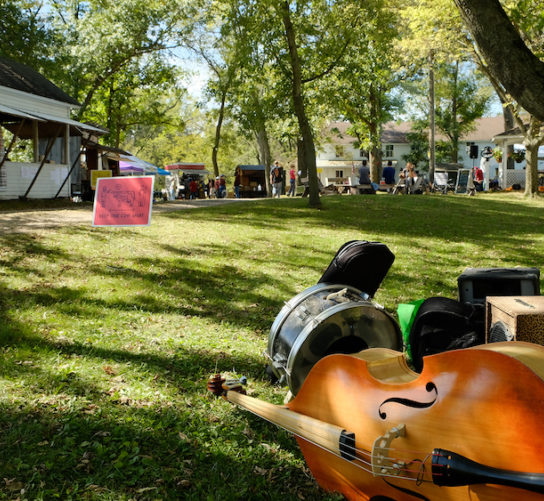 Musical instruments set near a tree before a musical performance in the tabernacle at Witwen Park for the 2021 Fermentation Fest: Grassland Edition.